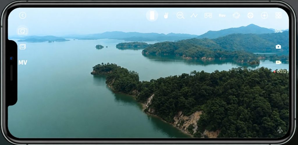 Aerial footage of a lake and mountains captured by a camera drone
